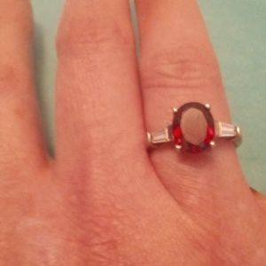 Two carat garnet ring with simulated diamonds on each side